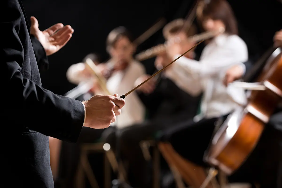 A conductor in front of an orchestra during a concert